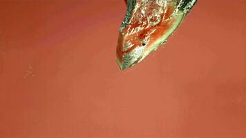 Watermelon slices fall under the water. Filmed on a highspeed camera at 1000 fps. High quality FullHD footage video