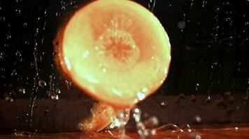 Knife cuts carrots with splashes. Filmed on a highspeed camera at 1000 fps. High quality FullHD footage video