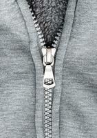 Close up zipper on gray sweater photo