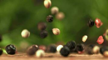 Peppercorn falling on the table. Macro shot. Filmed on a highspeed camera at 1000 fps. High quality FullHD footage video