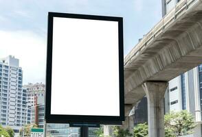 Outdoor pole vertical light box billboard with mock up white screen. Clipping path for mock up photo