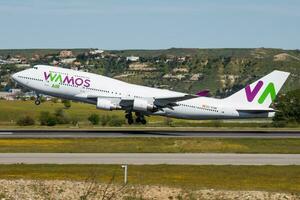 Wamos Air passenger plane at airport. Schedule flight travel. Aviation and aircraft. Air transport. Global international transportation. Fly and flying. photo