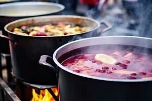 Beverages fruits and berries hot mulled wine in pots with steam in street food market. Generative AI photo