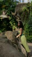 Young beautiful black african woman looking around in the woods outdoor. Woman portrait in the jungle, tropical forest video