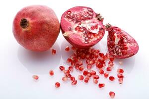 Pomegranate and seeds on white background photo