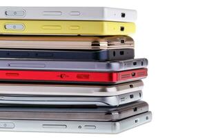 Pile of mobile phone. Heap of the different smartphones isolated on white background. photo