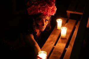 Calavera Catrina sitting on a throne. Sugar skull makeup. Dia de los muertos. Day of The Dead. Halloween. photo