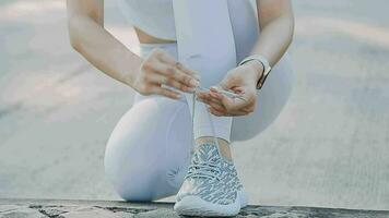 young woman runner tying shoelaces video