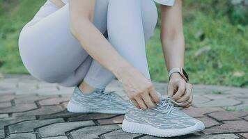 young woman runner tying shoelaces video