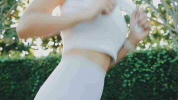 Young woman stretching before running while looking for beautiful landscape on roadside. Sports and Recreation video