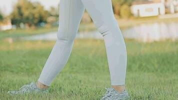 Young woman stretching before running while looking for beautiful landscape on roadside. Sports and Recreation video