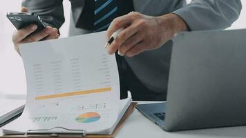 Finance Investment Ideas on Company Growth Project Success Statistics A professional investor working on starting a project for a strategic plan with a document, a laptop, on an office table. video
