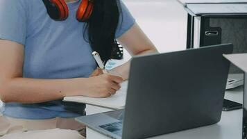 Charming Young asian businesswoman sitting on laptop computer in the office, making report calculating balance Internal Revenue Service checking document. video