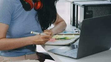 Charming Young asian businesswoman sitting on laptop computer in the office, making report calculating balance Internal Revenue Service checking document. video