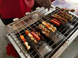 various types of satay, skewer, sausage, skin, yakitori, chicken on hot coals. bakaran photo