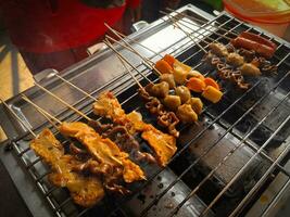 various types of satay, skewer, sausage, skin, yakitori, chicken on hot coals. bakaran photo