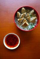 chilli oil. Homemade chilli oil in a glass liite plate, on table photo