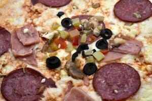 Meat pizza with vegetables. Delicious Italian flatbread. A pizzeria product. photo