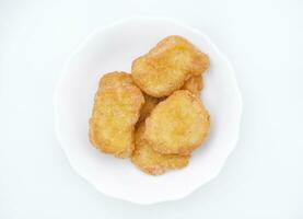 Chicken nuggets on a white plate. Fried chicken meat in pieces. photo