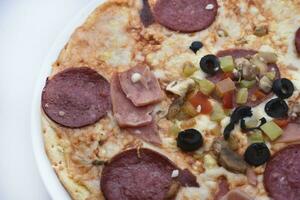 Meat pizza with vegetables. Delicious Italian flatbread. A pizzeria product. photo