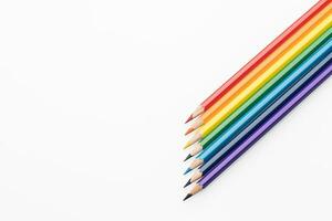 Rainbow color pencils in the form of an arrow from the right corner top view photo