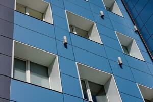 generic blue office building wall with windows and composite aliminium panels, diagonal upward view photo