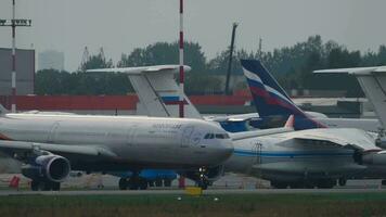 MOSCOW, RUSSIAN FEDERATION JULY 29, 2021 - Airbus A330 of Aeroflot on taxiway at Sheremetyevo airport. Passenger airliner Russian Airlines on the airfield. Row of planes in the background video