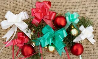 christmas bows and balls on rustic background photo