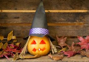 candles and decoration with halloween pumpkins with witch faces and witch photo