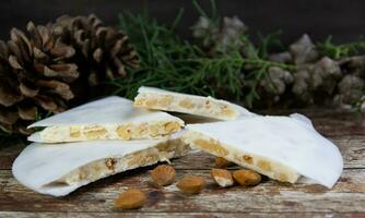 Almond nougat with Christmas decorations photo