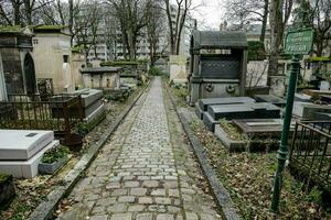 a cemetery with many tombstones and a green sign photo