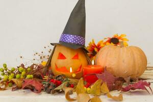 candles and decoration with halloween pumpkins with witch faces and witch photo