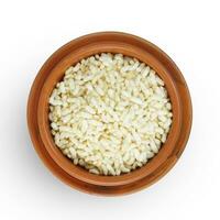 Top view of Indiana Puffed Rice in a brown clay pot, isolated on a white background. photo