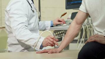 Man getting his wrist bones checked by doctor using ultrasound scanner video