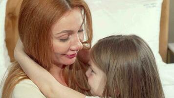 Happy mother hugging her little daughter hugging, smiling to the camera video