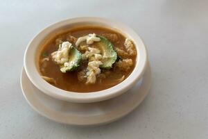 Mexican aztec soup with chicharron avocado cheese and tortilla photo