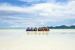 Happy family lying together on the beach, Thailand photo