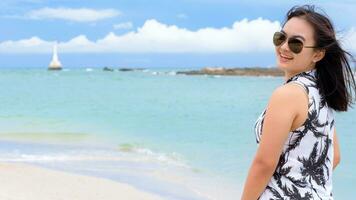 Beautiful woman tourist on the beach in Thailand photo