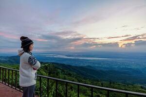 Woman tourist watching the sunrise photo