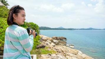 Young woman photography near the sea photo