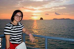 Women tourist cruising at sunset photo