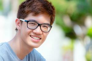 Closeup Asian teenage boy smiling photo