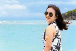 Beautiful woman tourist on the beach in Thailand photo