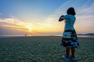 Woman tourist taking photo on the beach