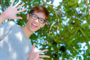 Asian fun teenage boy wearing glasses photo