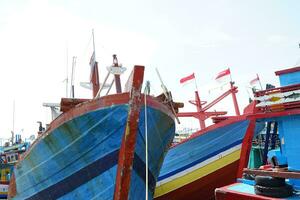 PATI, INDONESIA - July 21, 2022 harbor atmosphere on pati beach photo