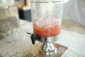 fresh guava juice in a glass container to serve in a restaurant photo
