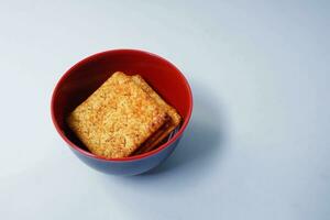 delicious snack, cracker biscuits in a bowl on a white background photo