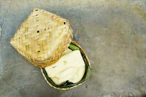 fermented cassava in a basket on a concrete background photo