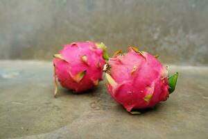 Fresh and healthy fruit, high anti-oxidant. dragon fruit on concrete background photo